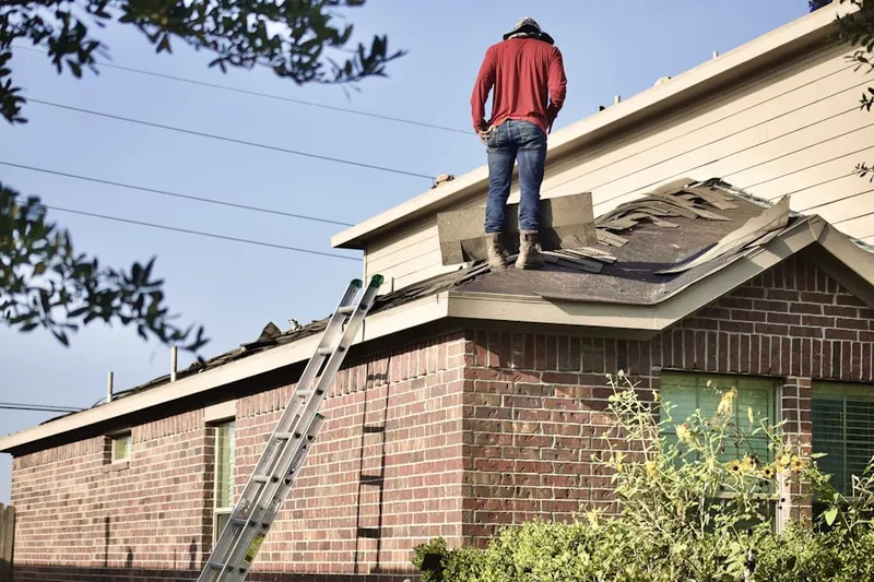 Professional roofer working on a residential roof in Sarepta